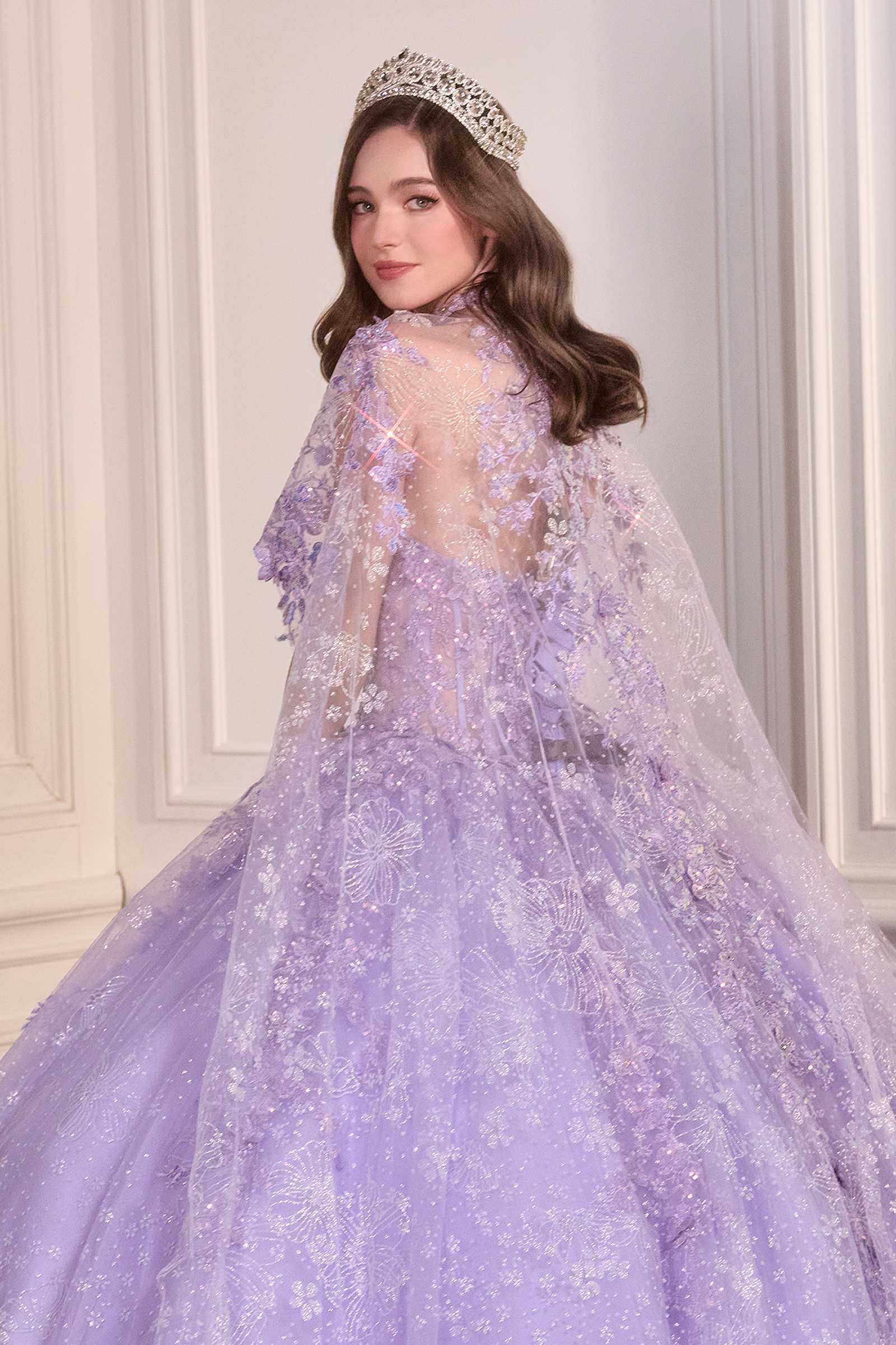 Lavender poofy quinceañera gown with sheer tulle cape overlay and sparkling fitted bodice