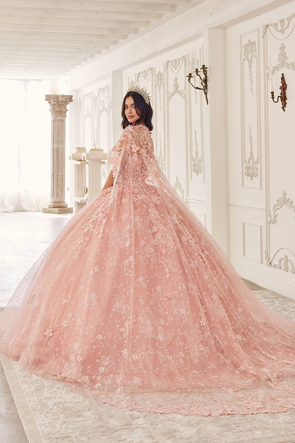 Back view blush pink poofy quinceañera gown with lace tulle cape and sweeping skirt
