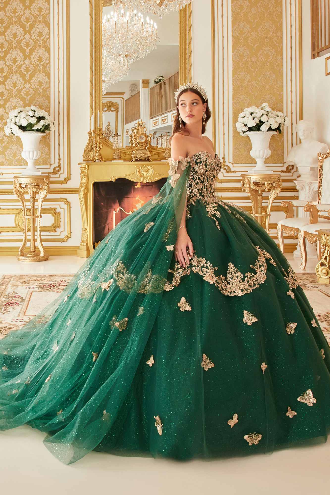 Emerald green strapless ball gown with tulle cape sleeves and butterfly lace motifs