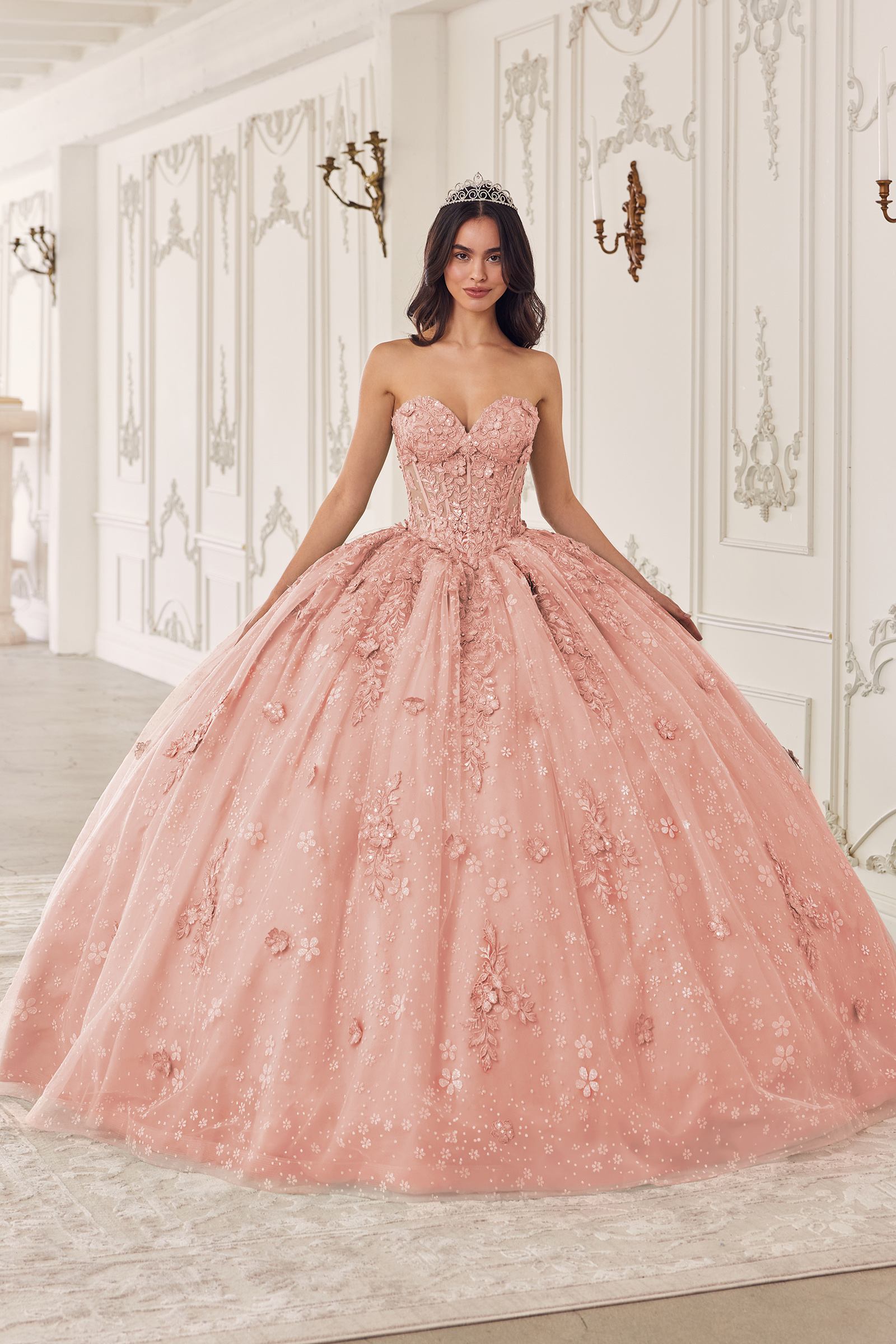 Blush pink A-line quinceanera dress with puff sleeves and sparkling embroidered bodice