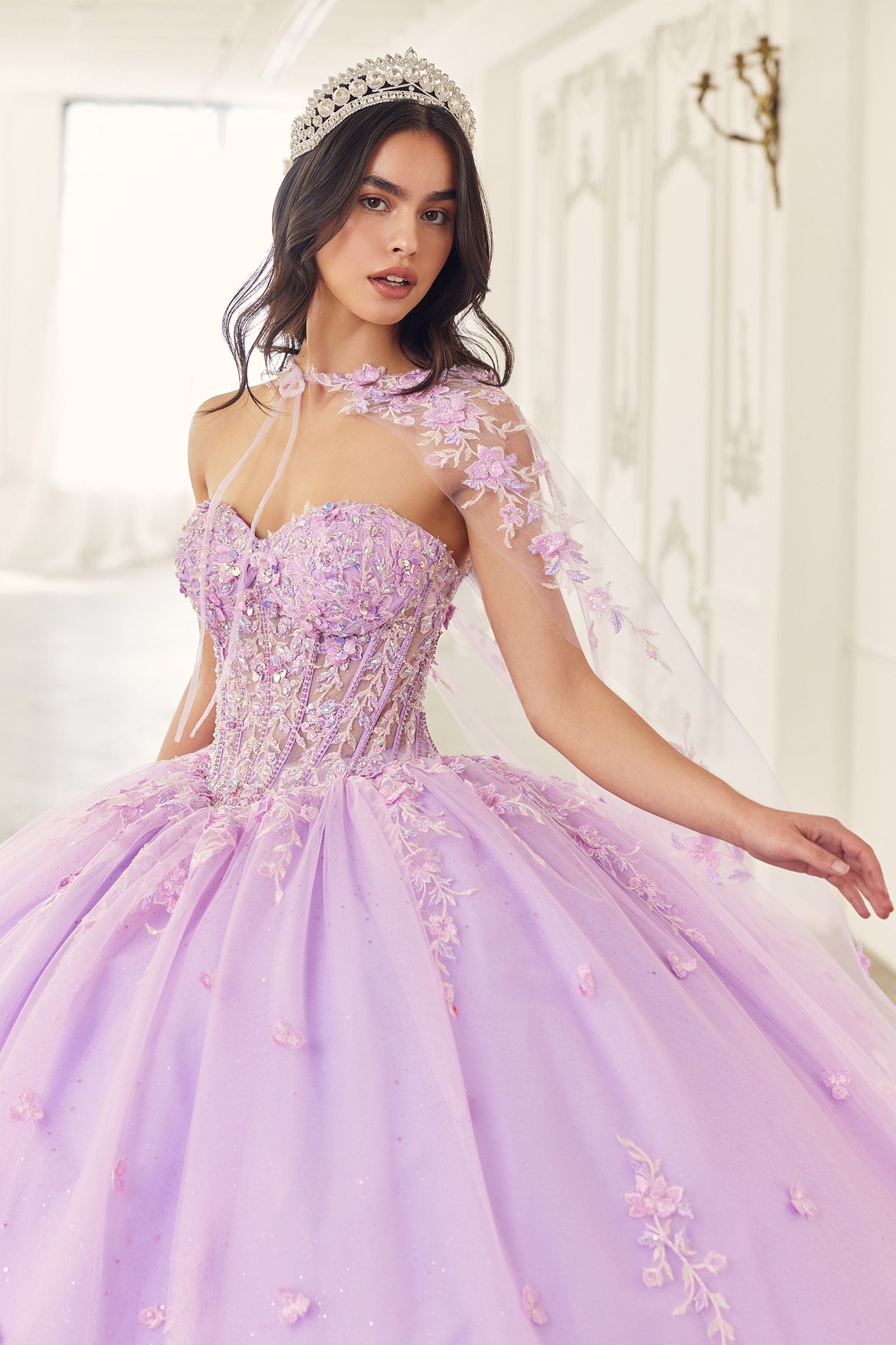 Lilac quinceanera gown with beaded corset bodice, floral appliques, and tulle cape