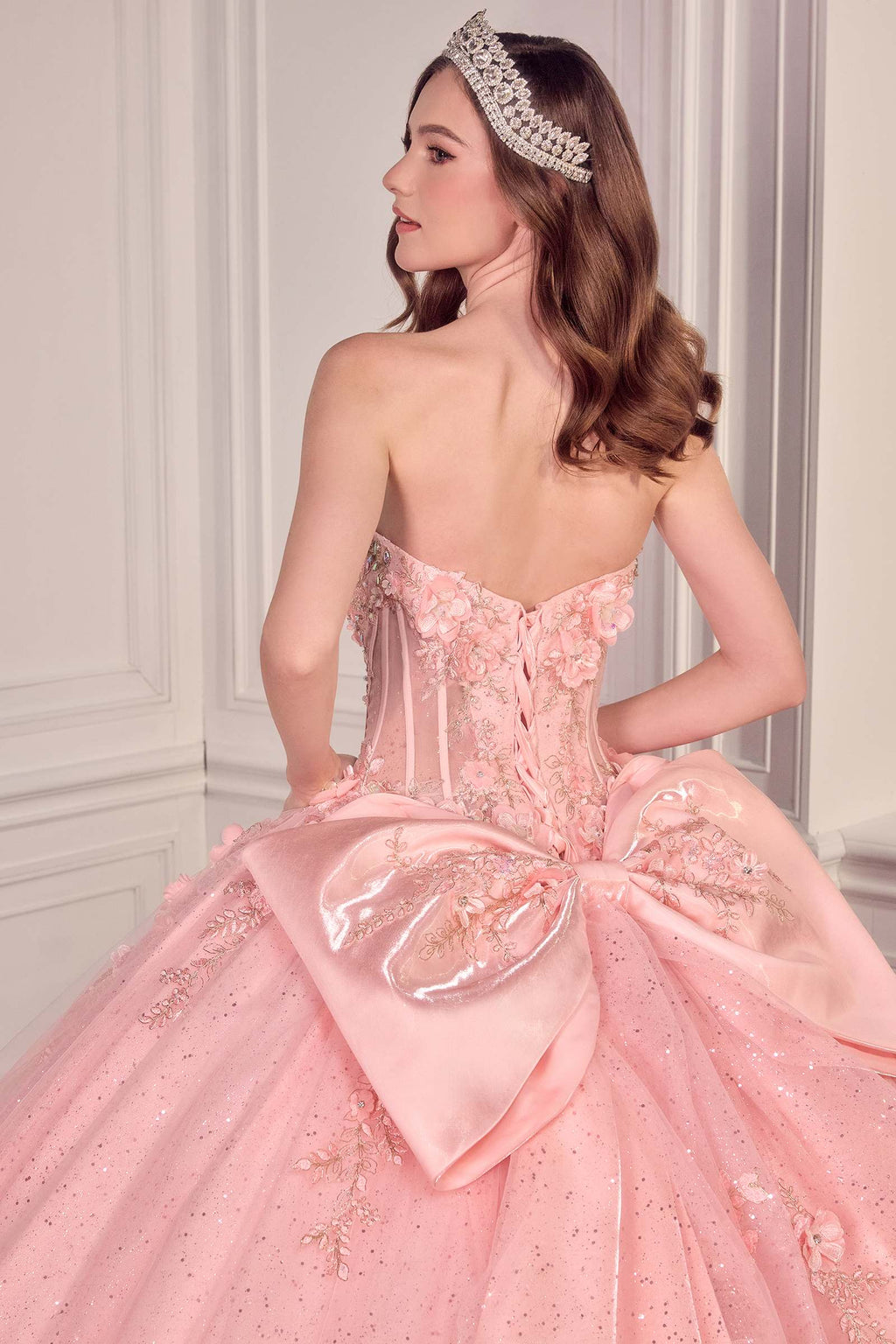 Light pink strapless sweetheart ball gown with corset bodice and bow at the waist
