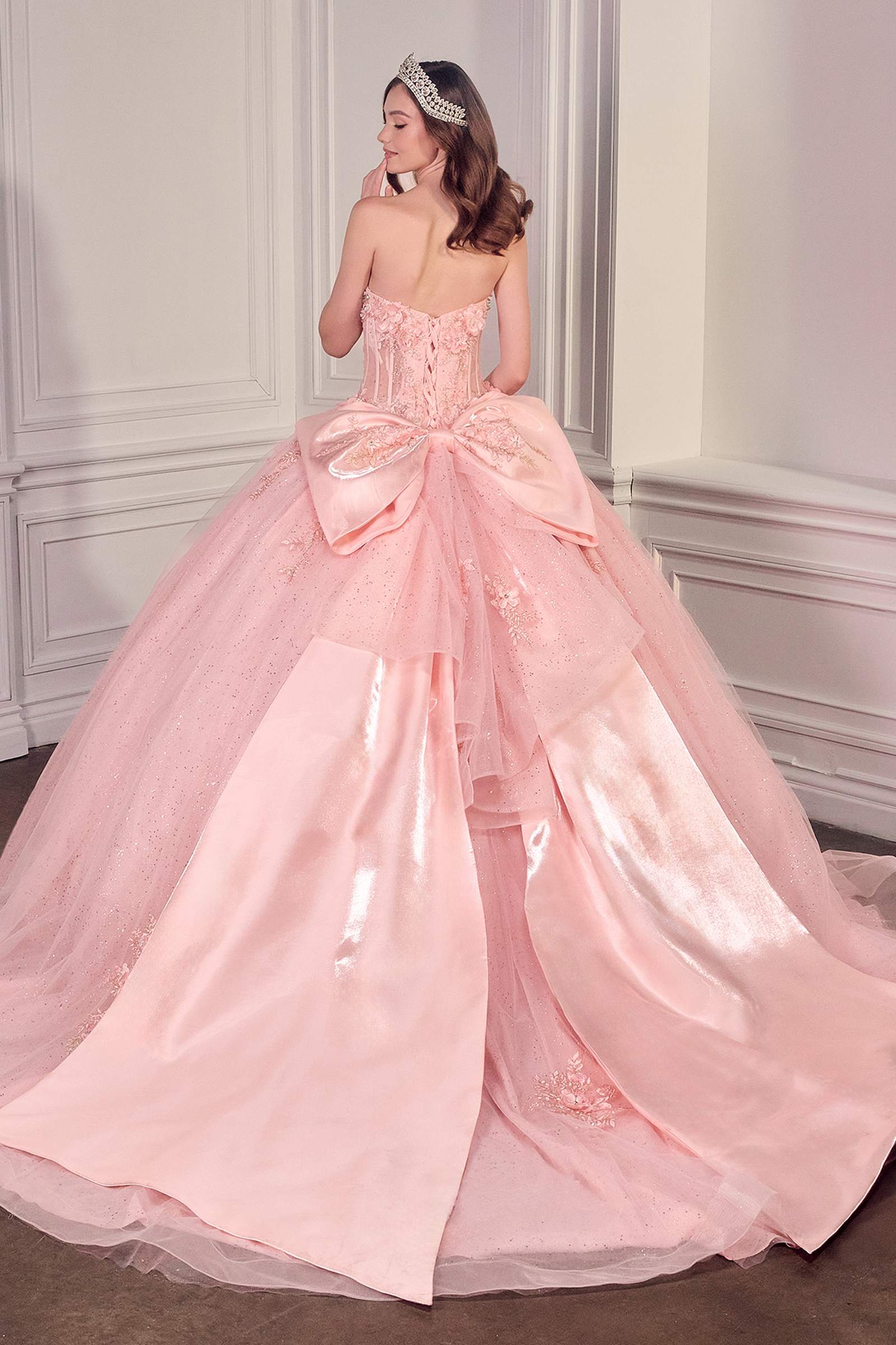 Light pink strapless sweetheart ball gown with corset bodice and full flowing tulle skirt