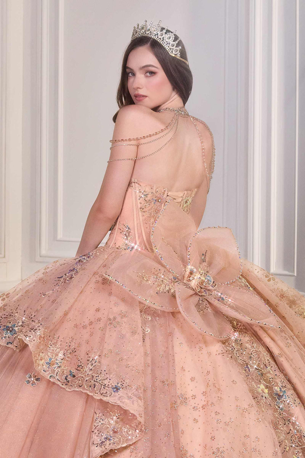 Rose gold ball gown with sheer tulle overlay, sparkling beadwork, ribbon bow details