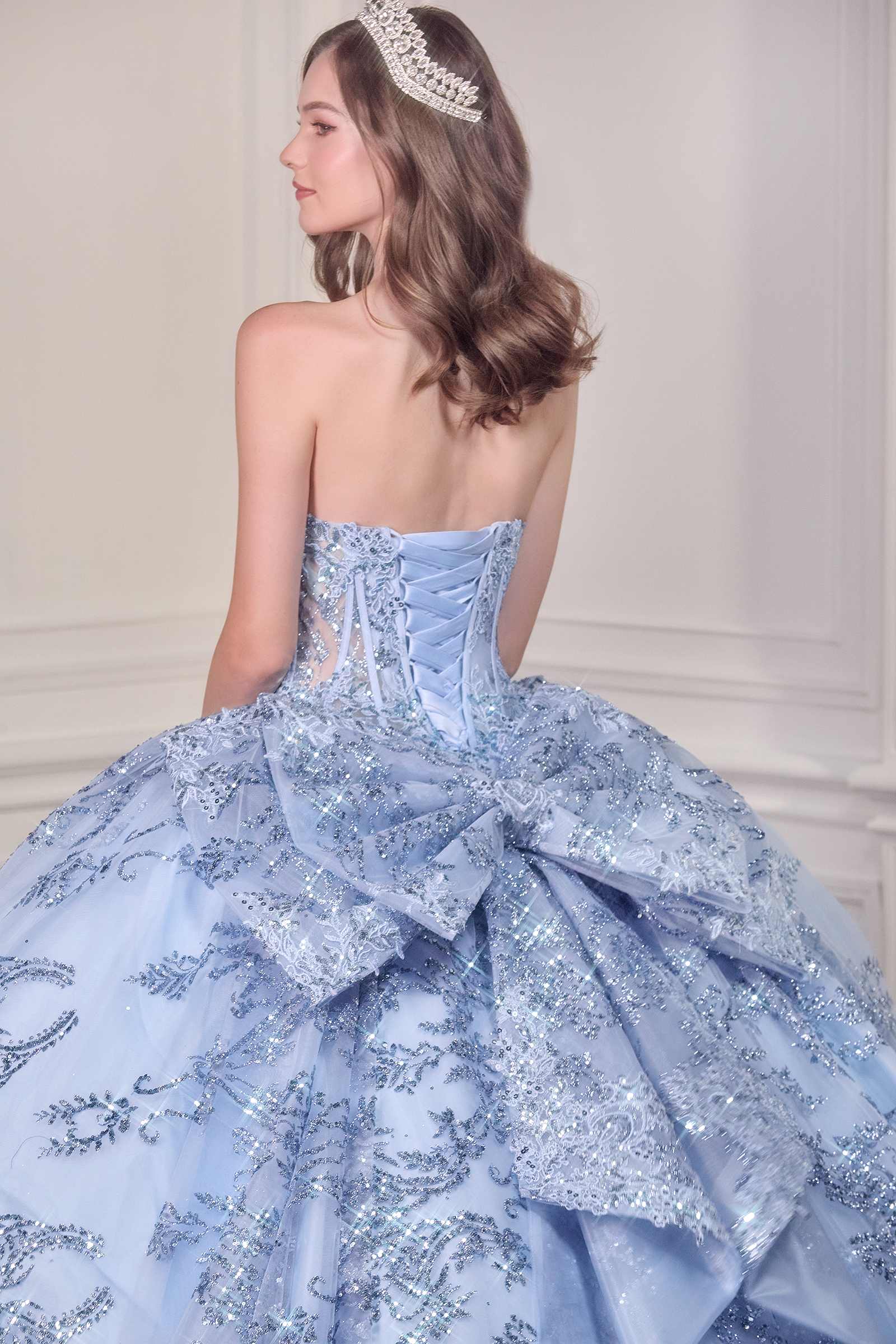 Blue strapless ball gown with sweetheart neckline, glitter embroidery, layered ruffles.