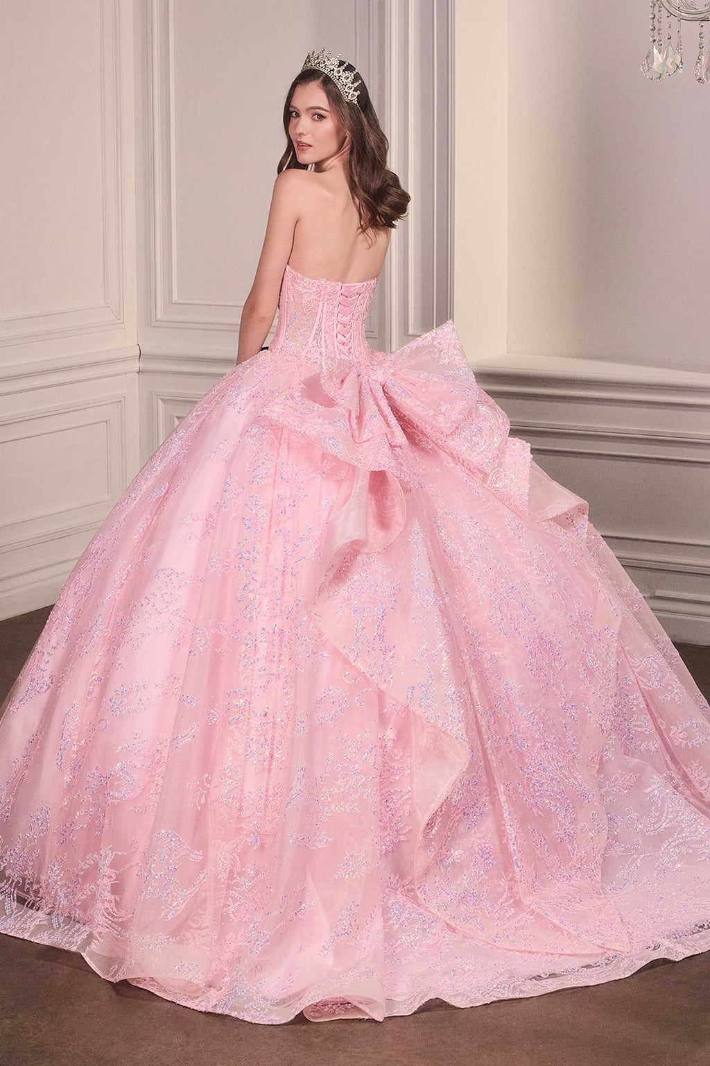 Pink strapless sweetheart ball gown with corset back detail and full tiered skirt.