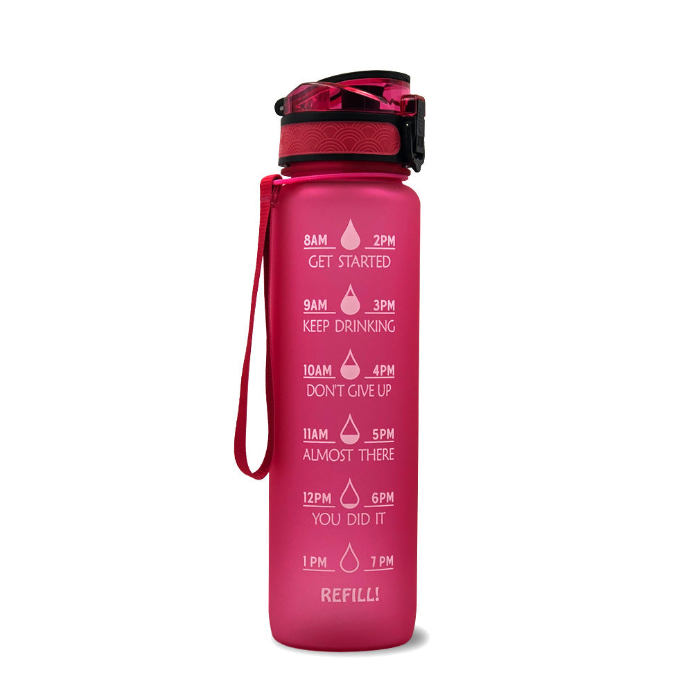 1L pink gradient water bottle with black lid and red wrist strap; time marker text