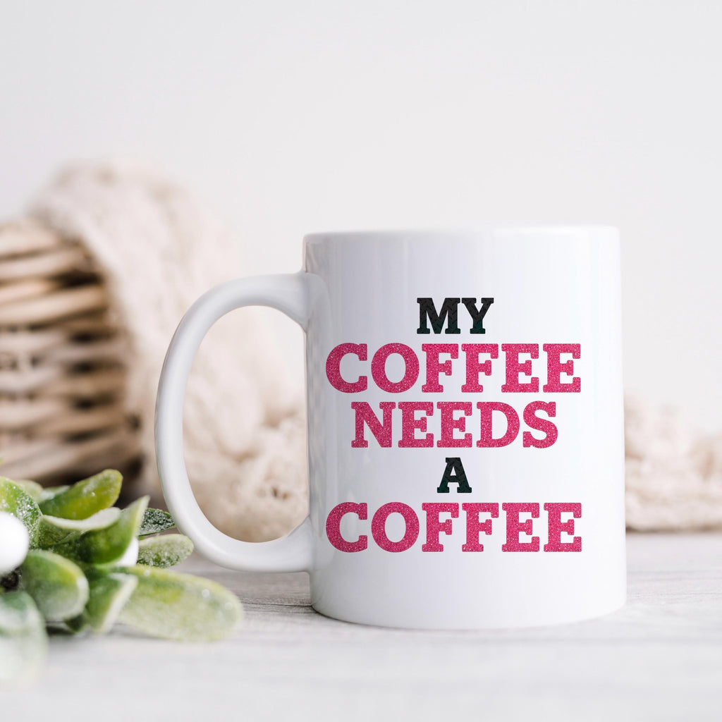 White ceramic mug with "MY COFFEE NEEDS A COFFEE" text, side view