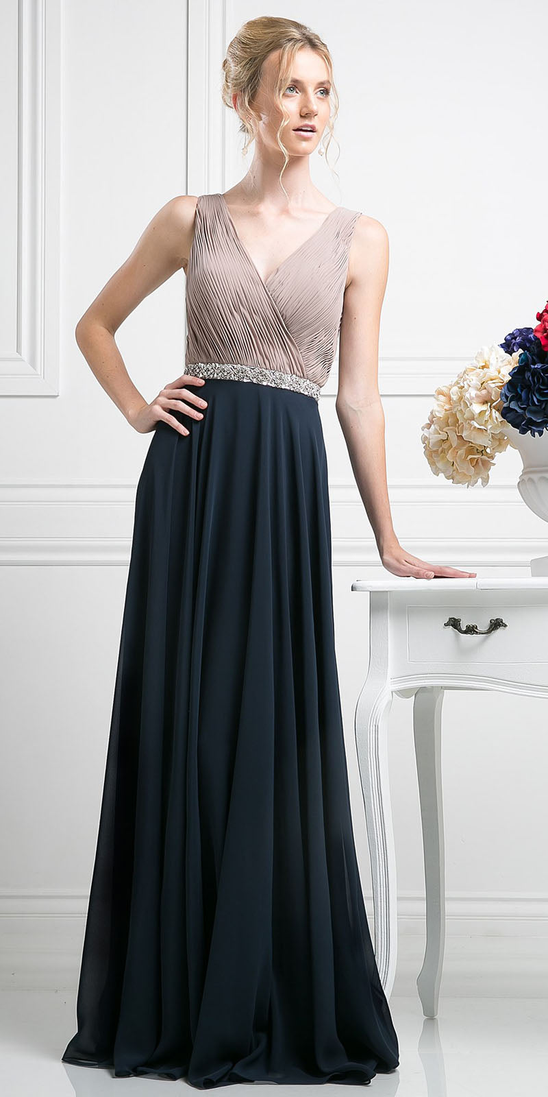 Sleeveless A-line chiffon dress with pleated V-neck bodice and dark flowing skirt