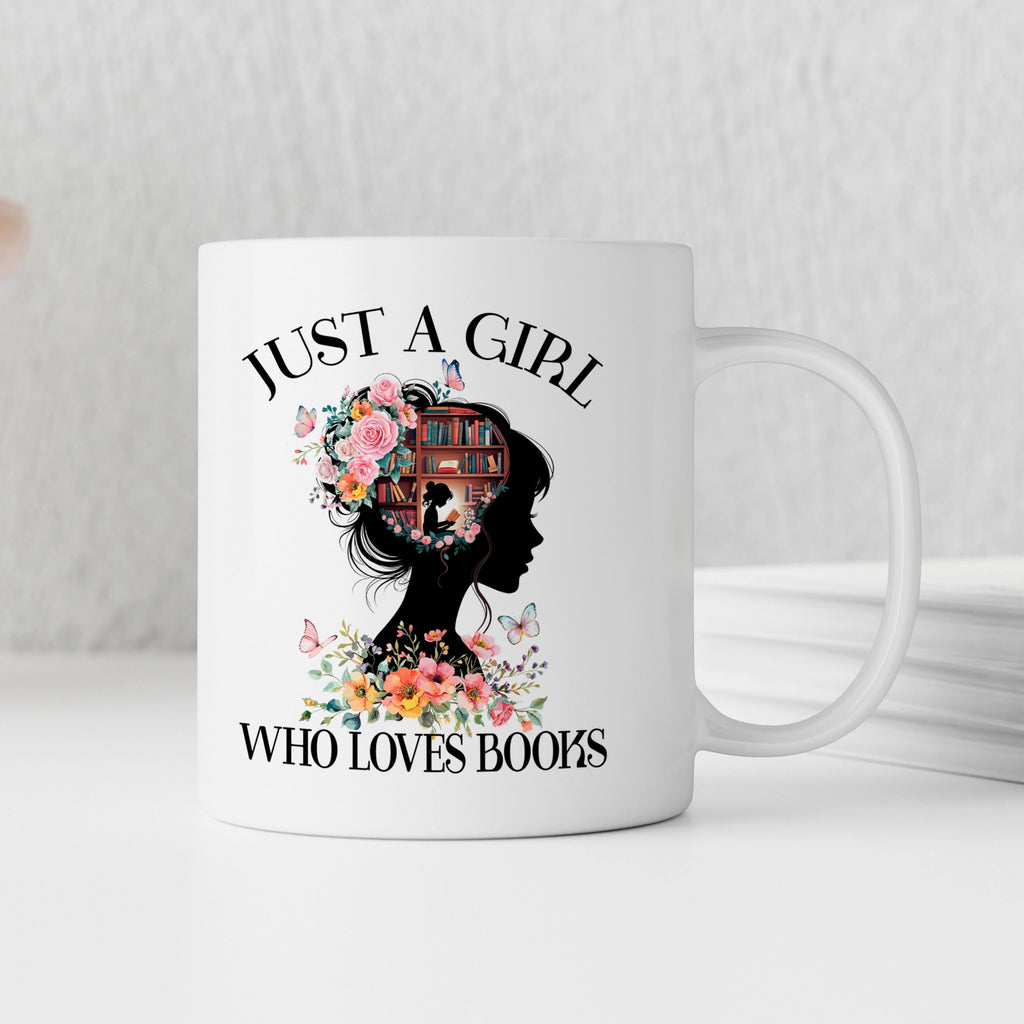 White ceramic coffee mug with “JUST A GIRL WHO LOVES BOOKS” print and floral book design.