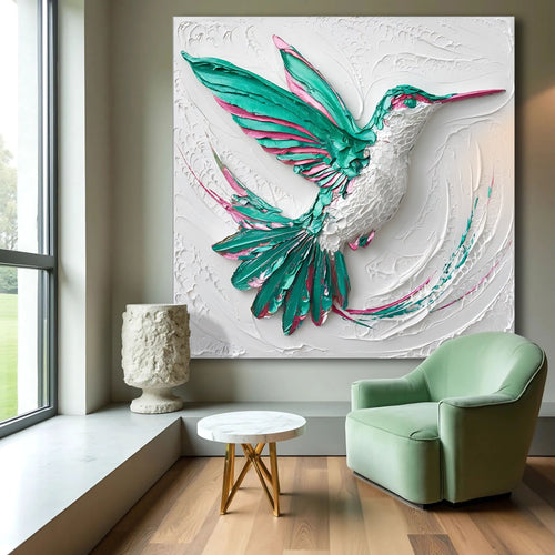 3D hummingbird wall art with teal wings and pink accents on a white textured relief panel