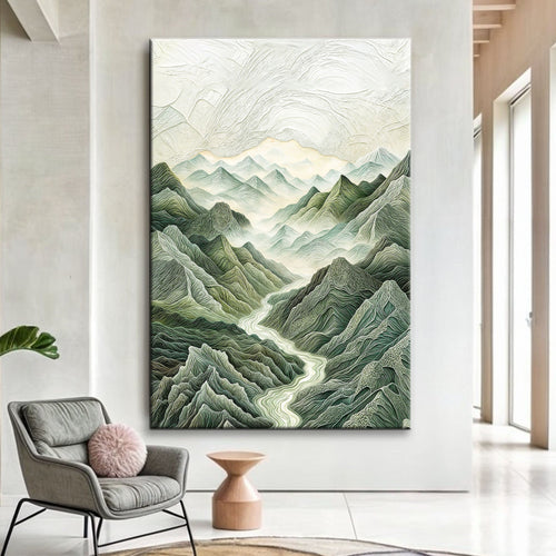 Mountain and river landscape wall art in a dark frame with layered green peaks