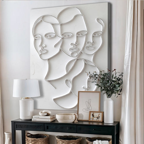 3D minimalist face wall art with three raised profile faces in white relief on canvas
