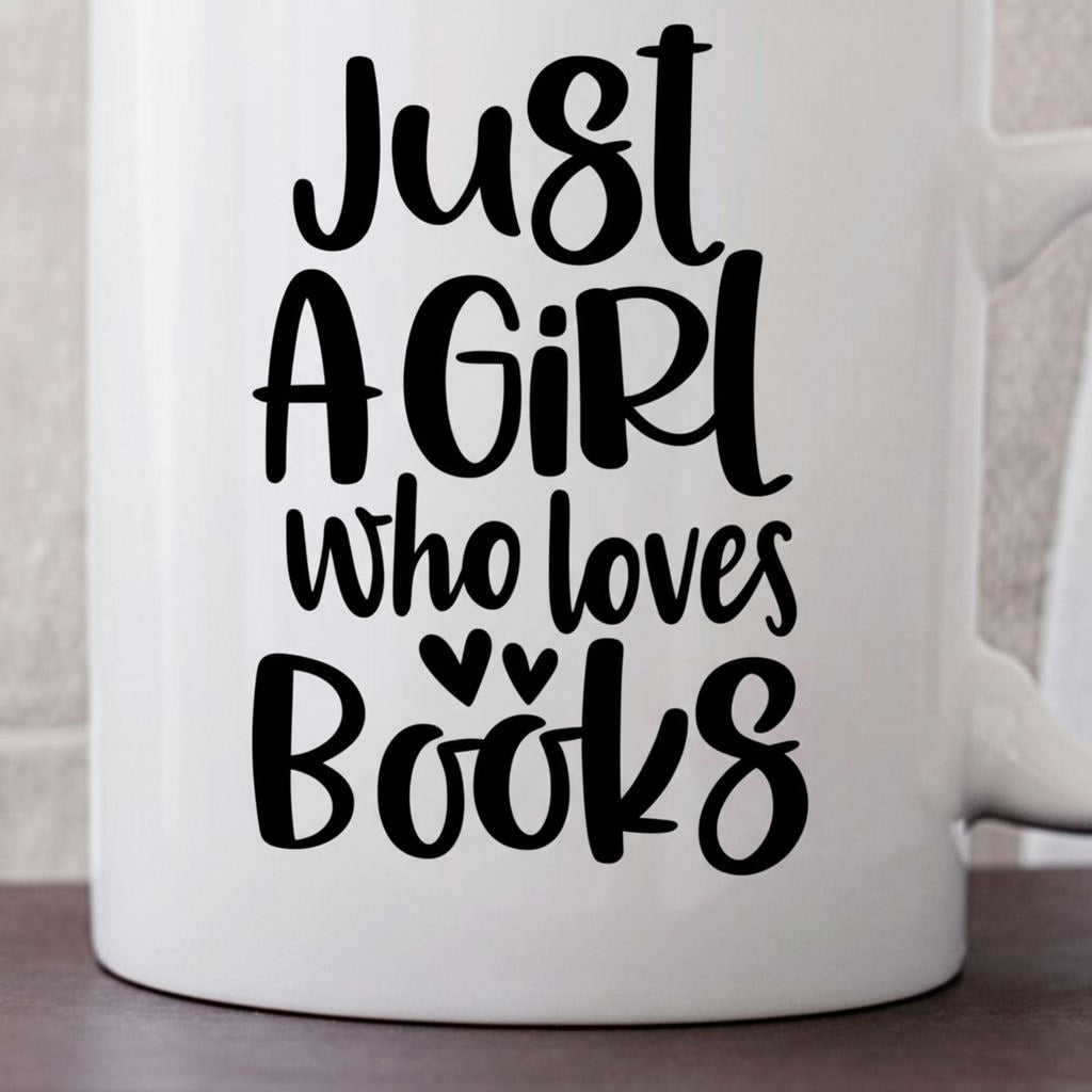White ceramic coffee mug close-up with "Just A Girl who loves Books" graphic
