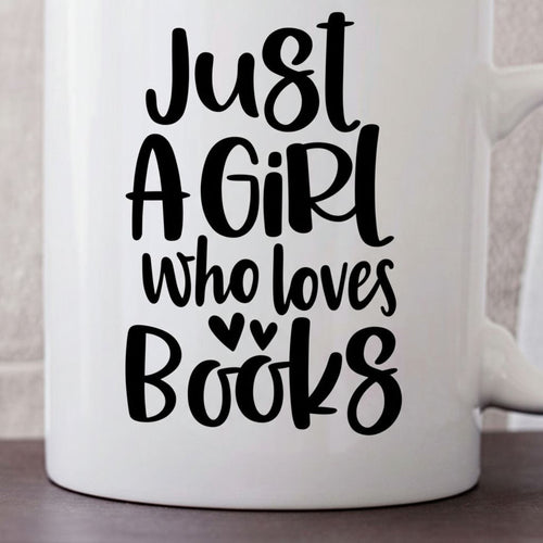 White ceramic coffee mug close-up with "Just A Girl who loves Books" graphic