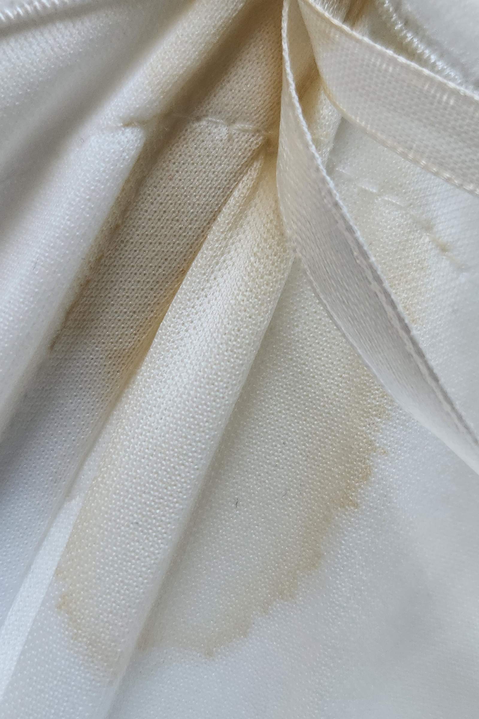 Off-white textured bridal gown fabric with layered drapes