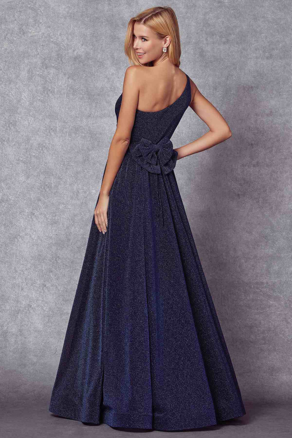 Navy one-shoulder glitter gown with twisted waist detail and flared full skirt