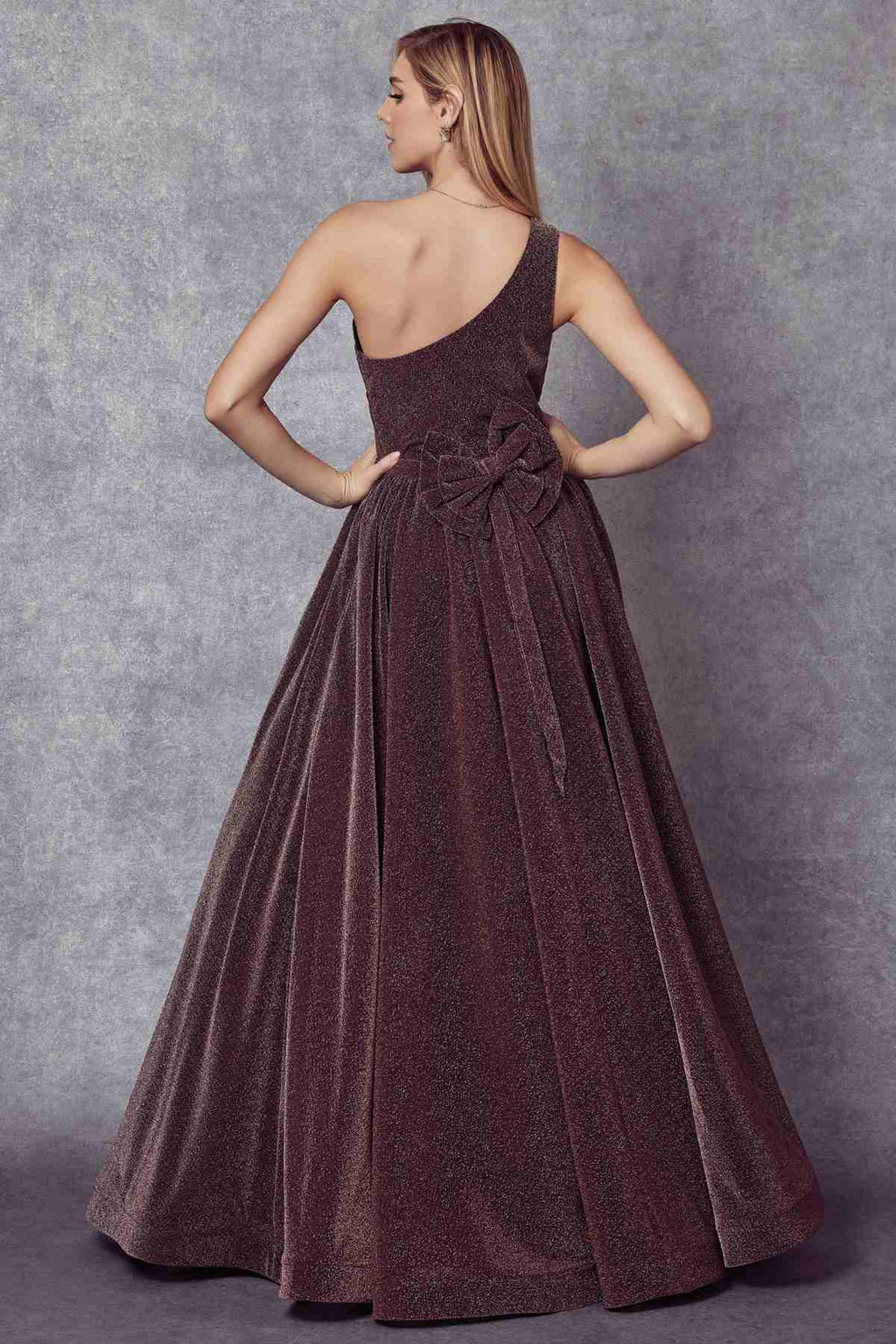 Dark plum one-shoulder glitter gown with sleeveless bodice and ruched waist