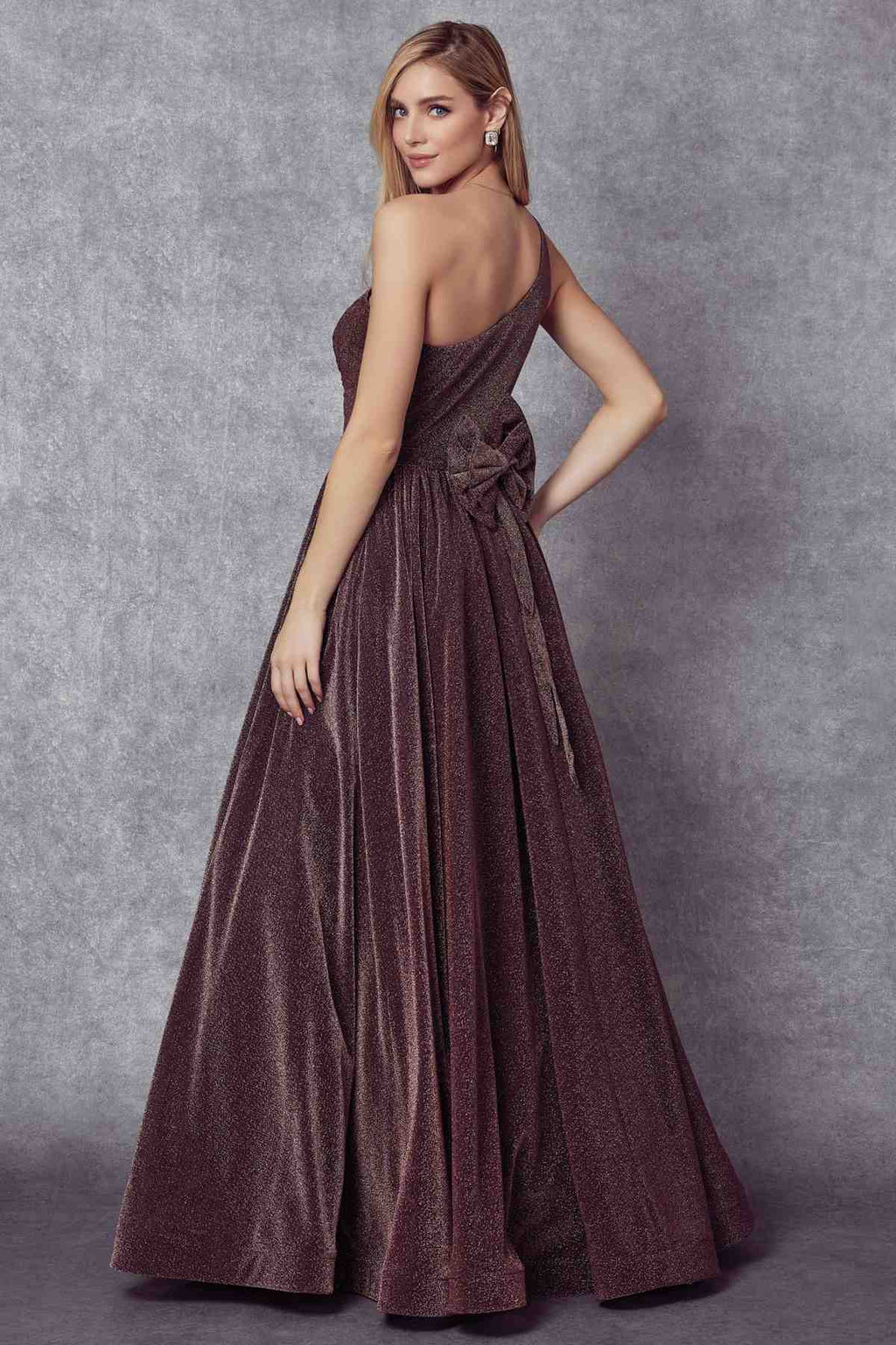 Dark plum one-shoulder sleeveless glitter gown with twisted waist and full maxi skirt