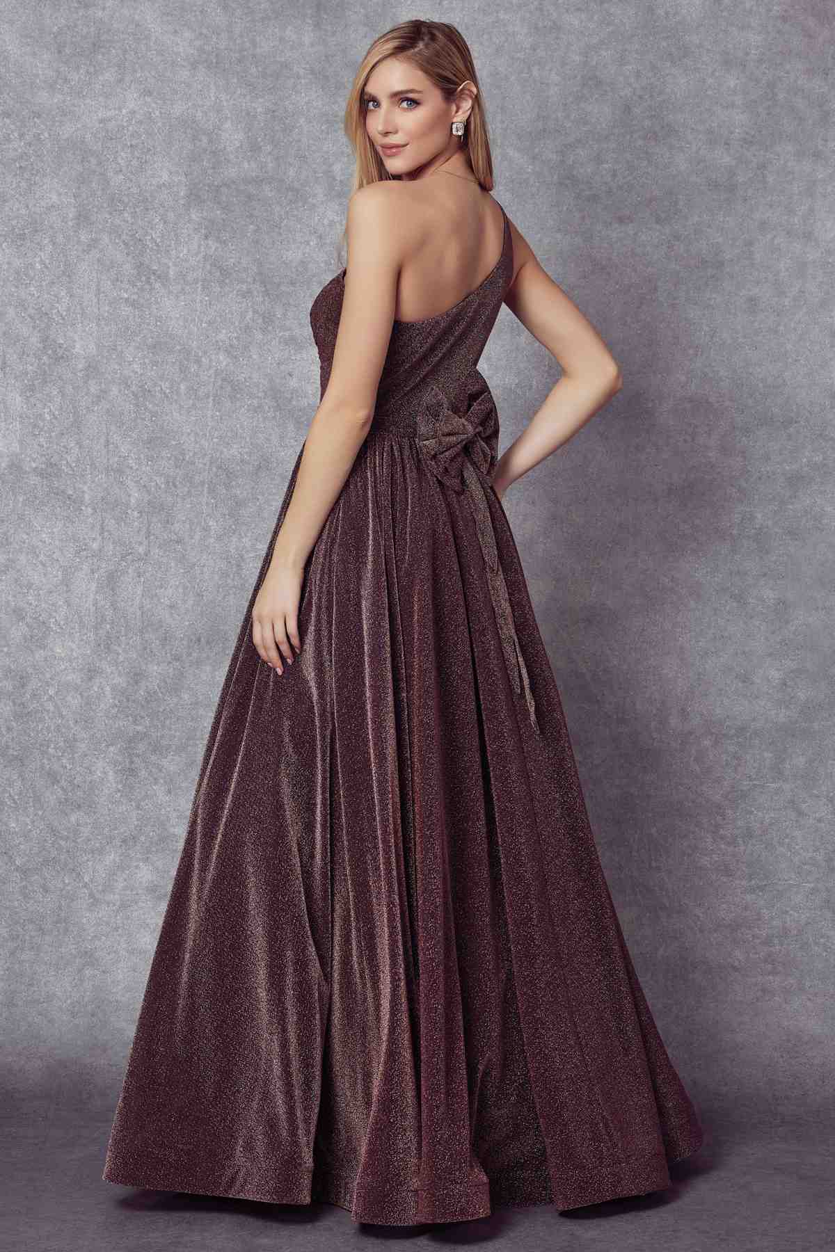 Dark plum one-shoulder sleeveless glitter gown with twisted waist and full maxi skirt