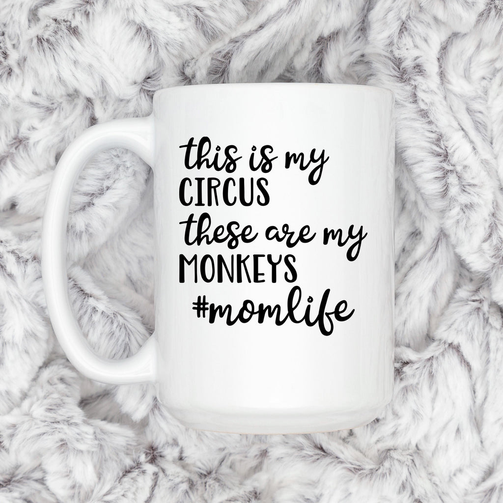 White ceramic coffee mug on gray faux-fur with "Circus" momlife message