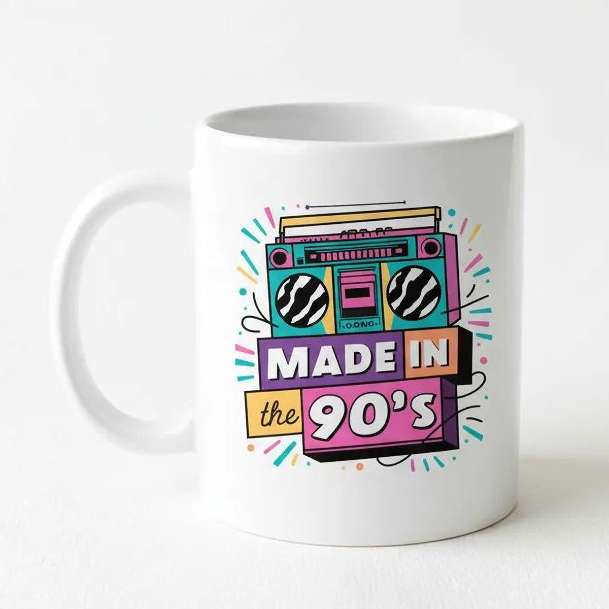 White ceramic mug with “Made in the 90’s” retro boombox graphic on front