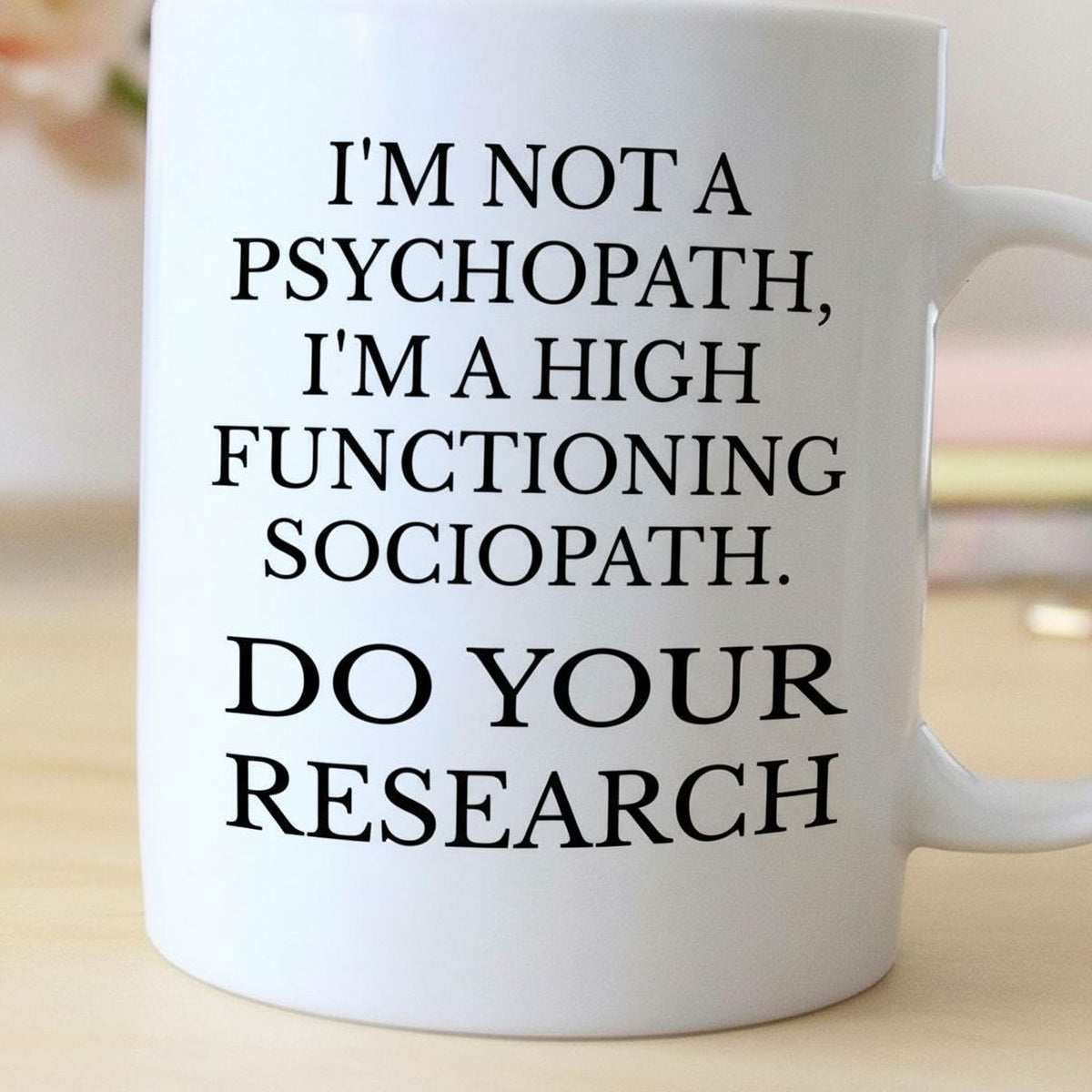 White ceramic coffee mug with black quote text: “DO YOUR RESEARCH”.