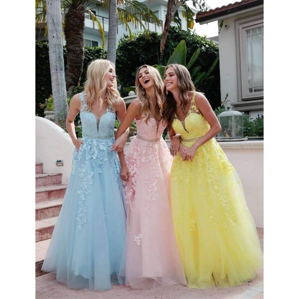 Three embroidered tulle A-line ball gowns in blue, blush, and yellow