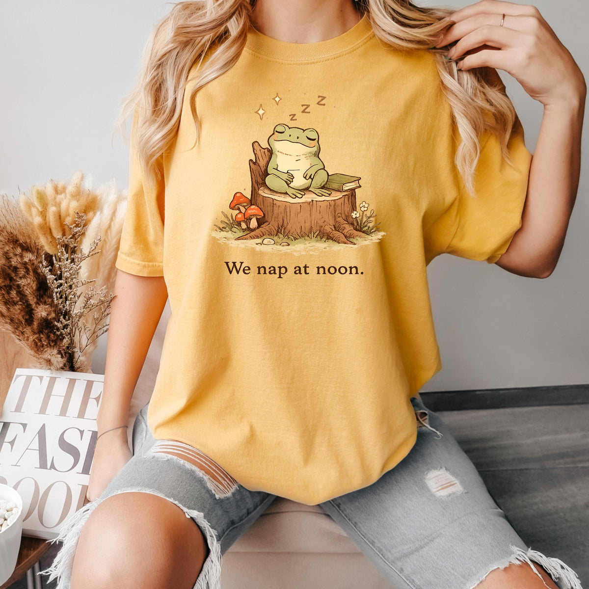 Mustard yellow frog T-shirt with sleeping frog on stump and “We nap at noon.” print