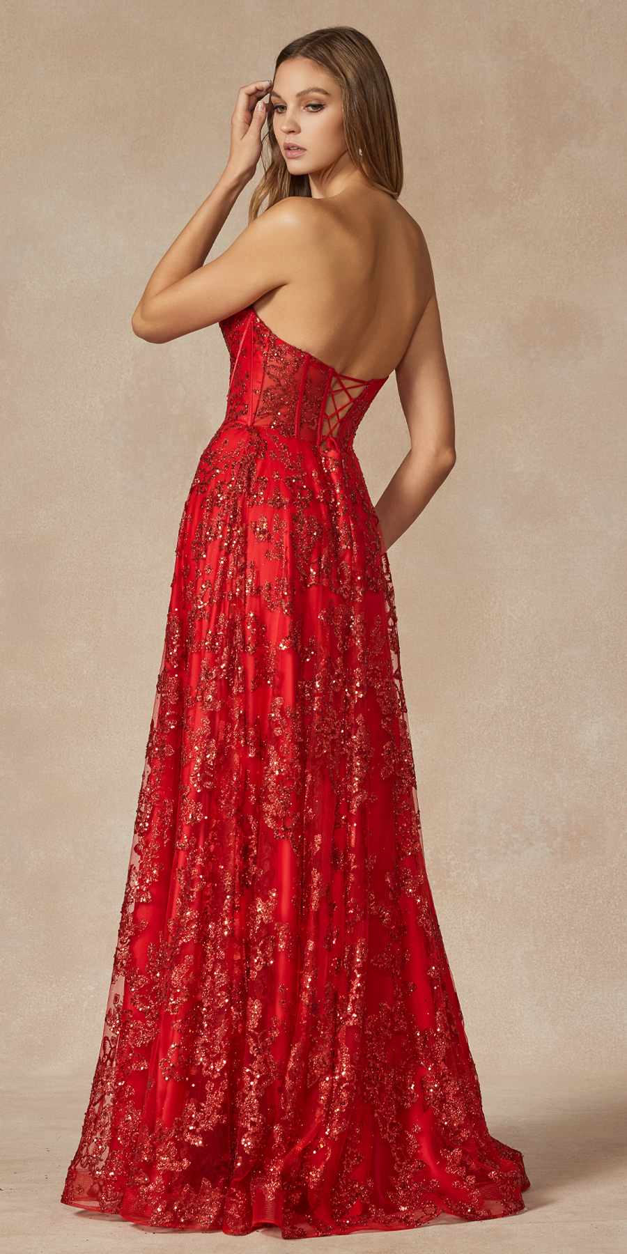 Red strapless corset gown with sweetheart neckline and shimmering embroidered pattern