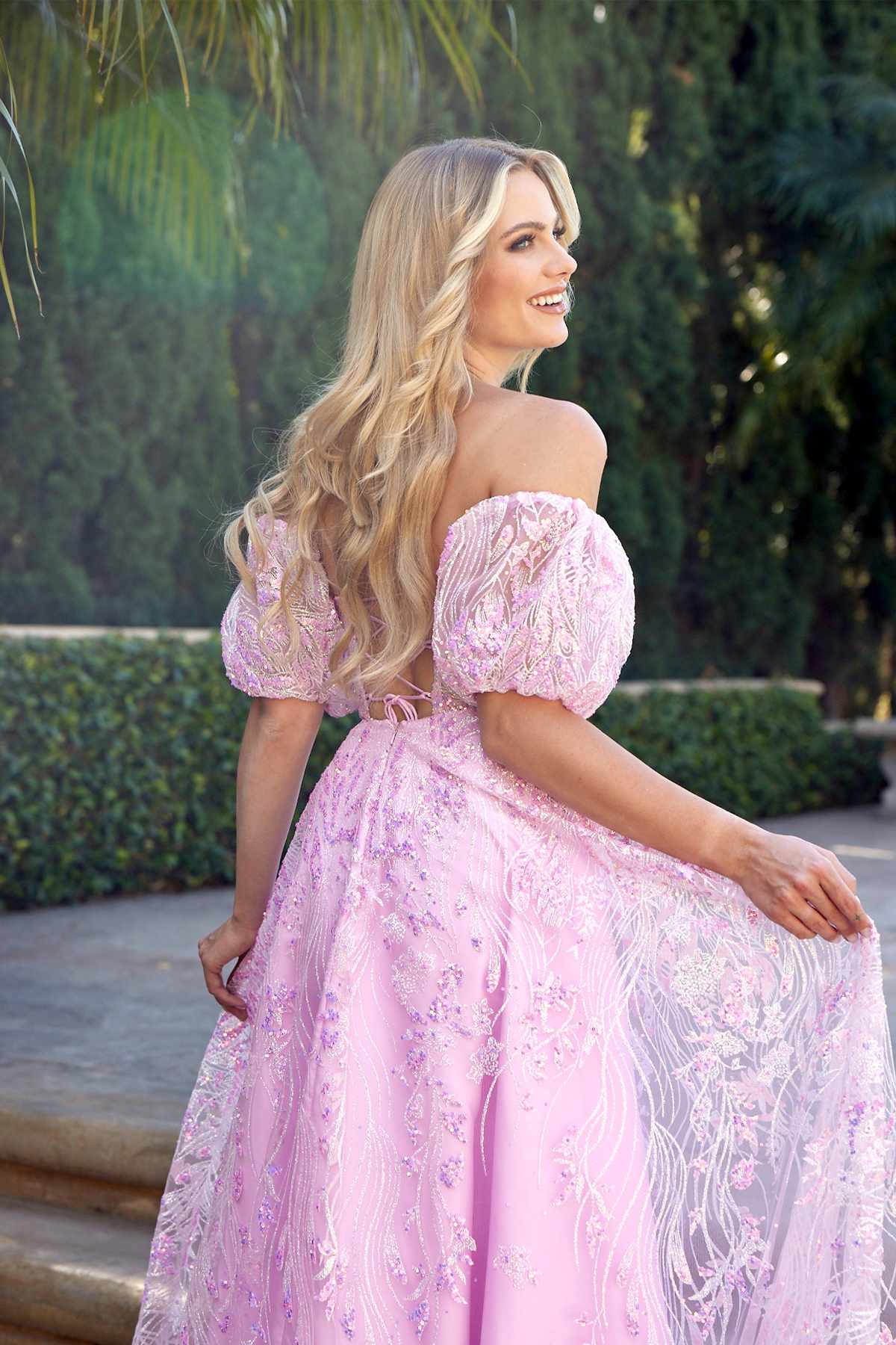Light pink strapless sequin tulle ballgown with puff sleeves and textured bodice