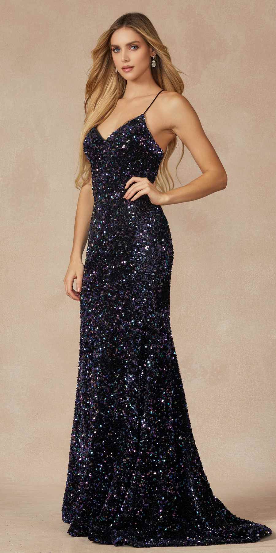 Fitted velvet sequin gown with V-neck and spaghetti straps, side hands pose