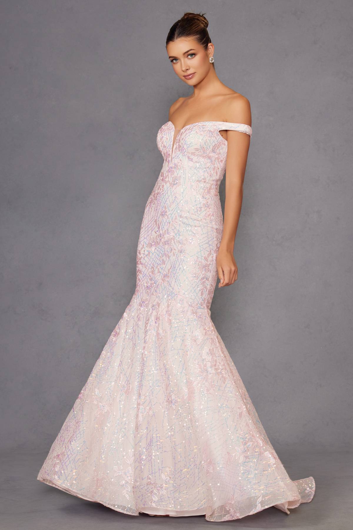 Blush mermaid gown with off-shoulder neckline and flared hem, glittering texture.