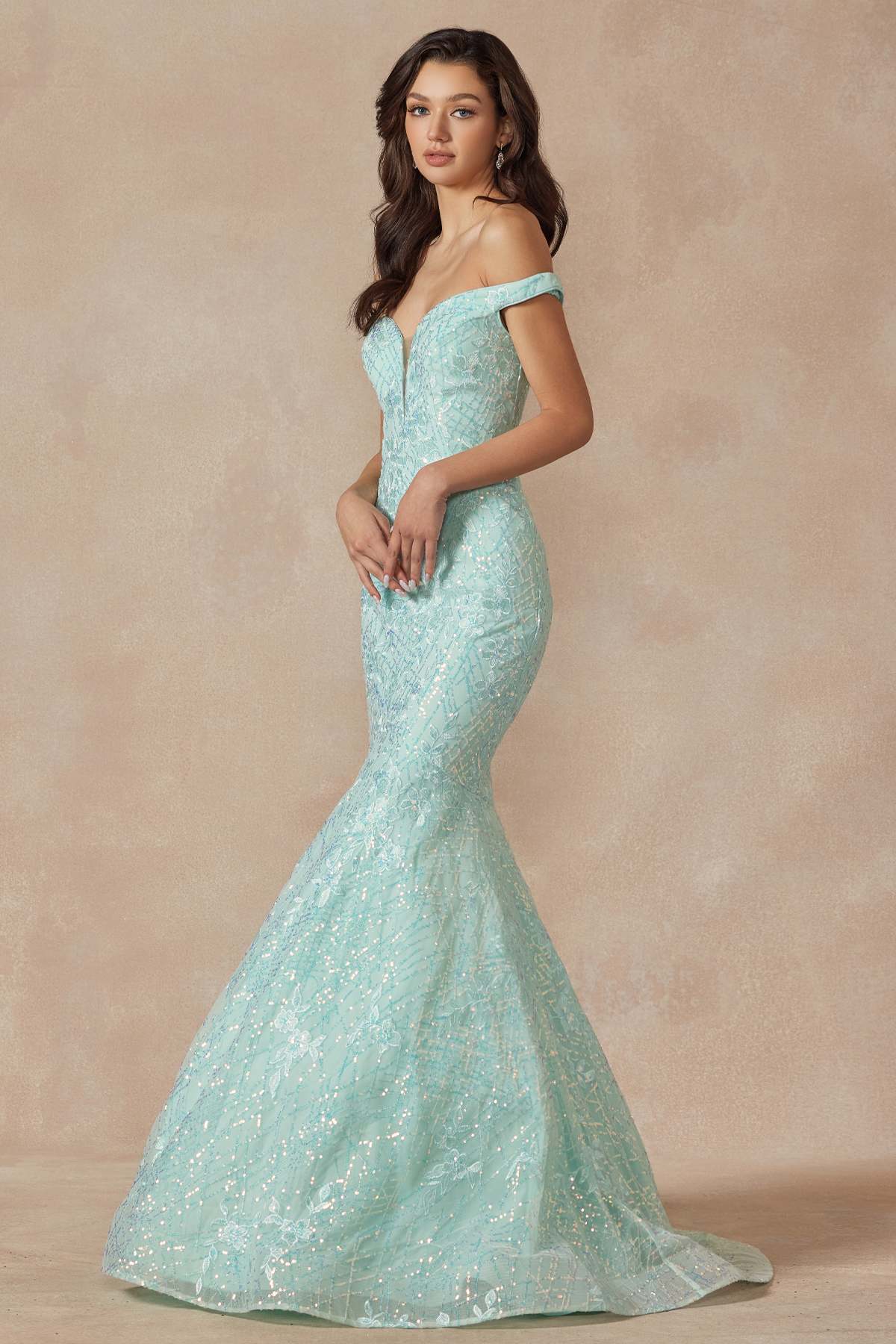 Mint mermaid gown with off-shoulder neckline and fitted sparkle fabric, side view.