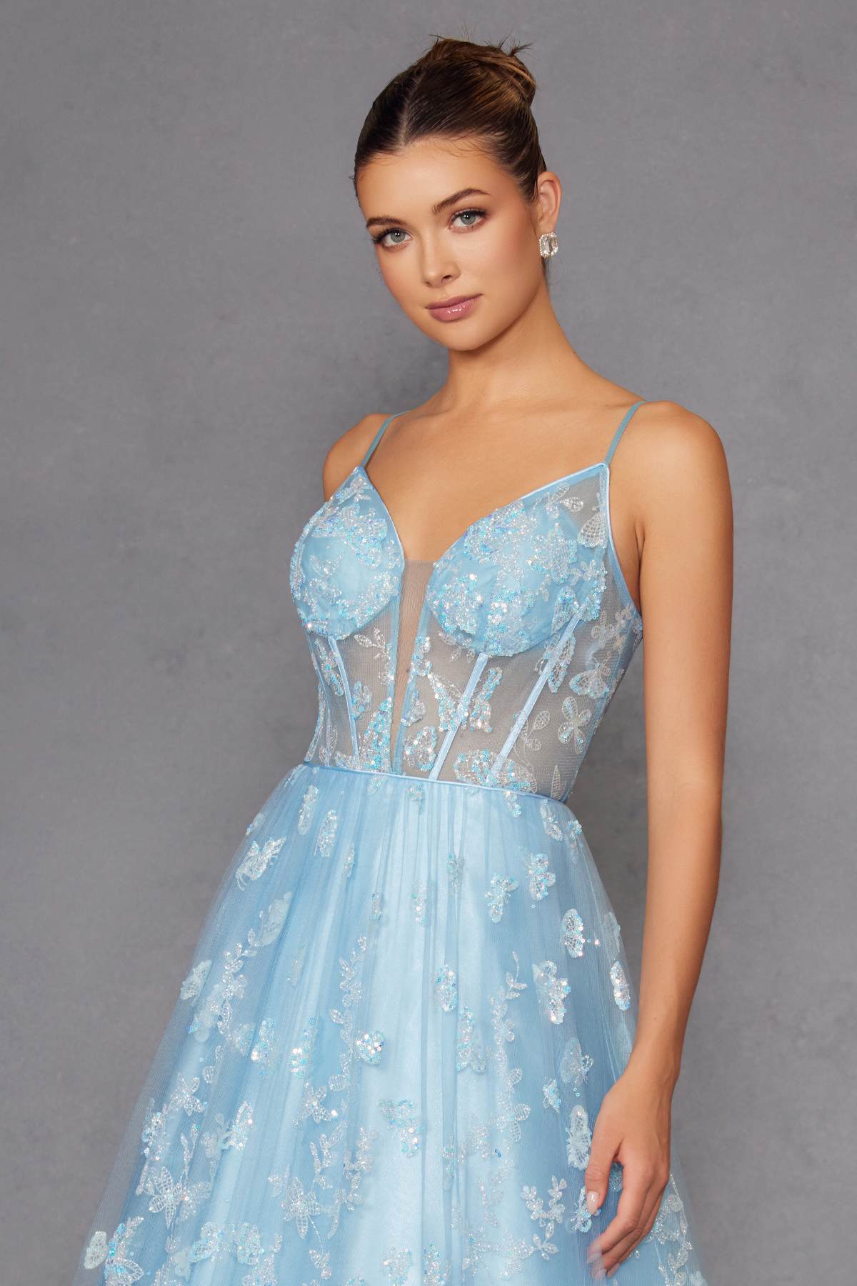Ice blue corset-style gown with V-neck, spaghetti straps, glitter butterfly embroidery