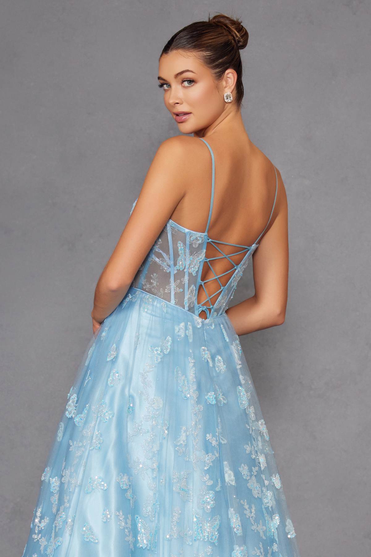 Ice blue long gown with open-back crisscross straps and glitter butterfly bodice detailing