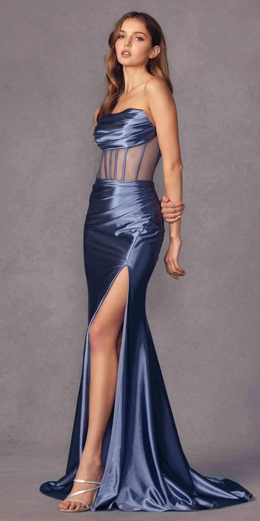 Blue satin slit dress with strapless gathered bodice, sheer vertical panels, side view