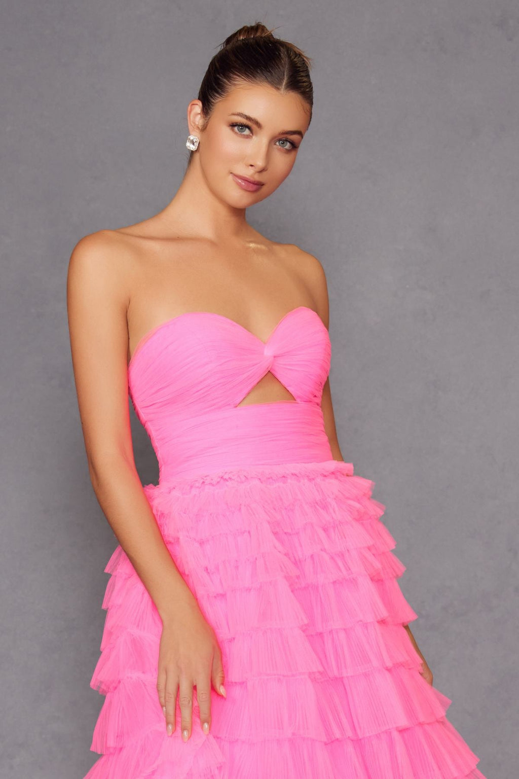 Neon pink strapless tiered tulle A-line gown with bow-tied bodice