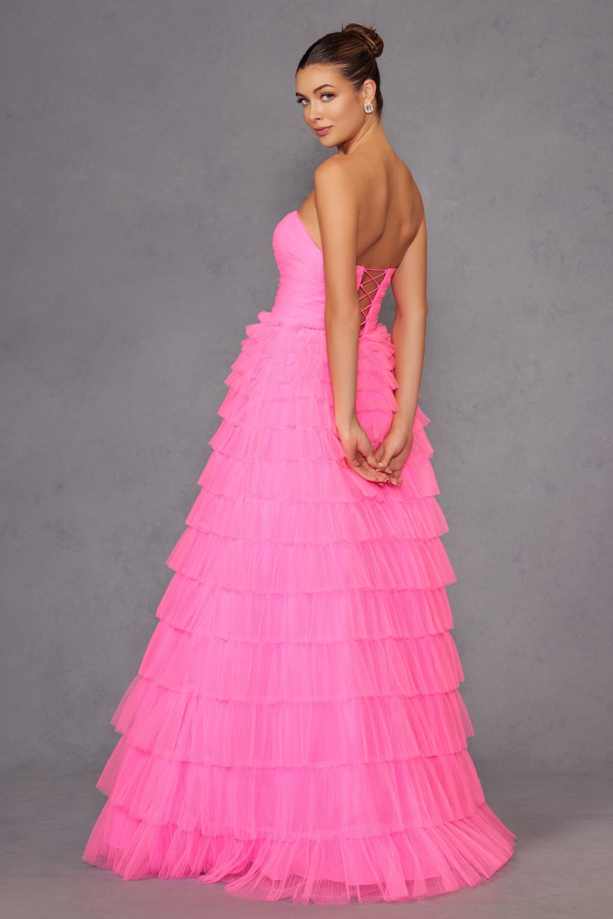 Neon pink strapless tiered tulle A-line gown with crisscross open back