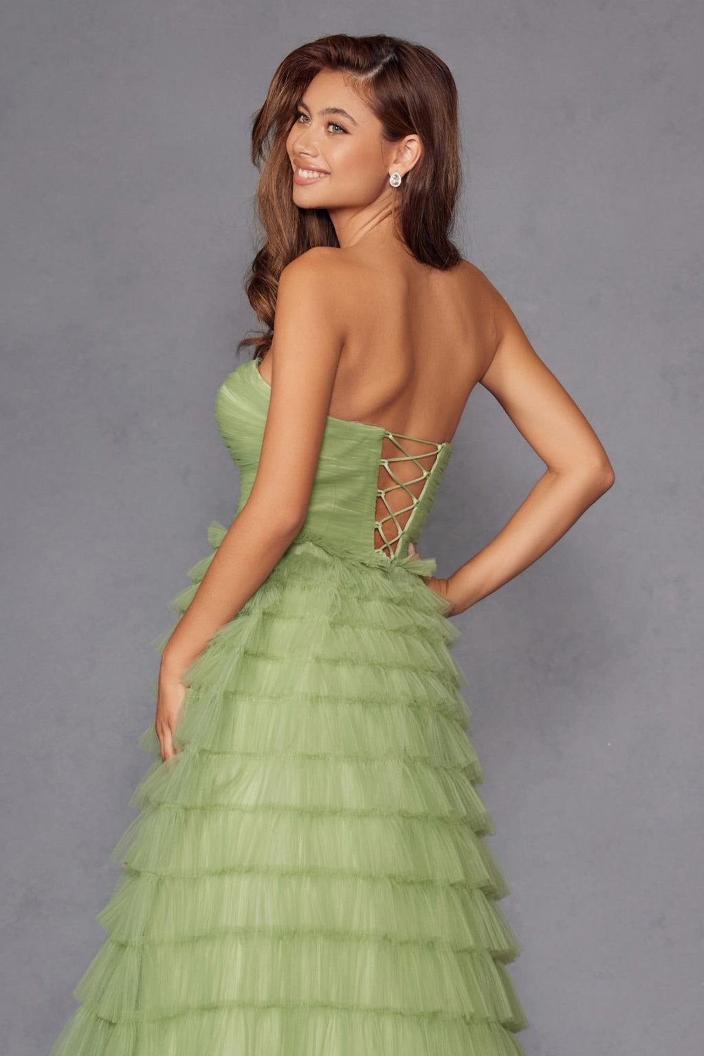 Sage green tiered tulle A-line gown with lace-up back and crisscross panel