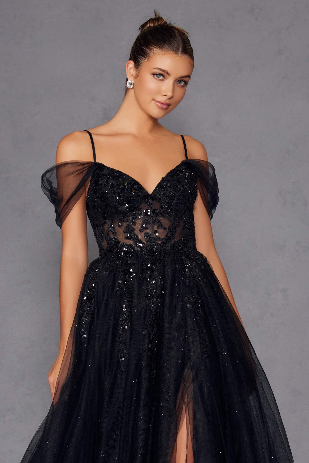 Black sweetheart corset gown with off-shoulder mesh sleeves, lace bodice, and sparkling tulle skirt