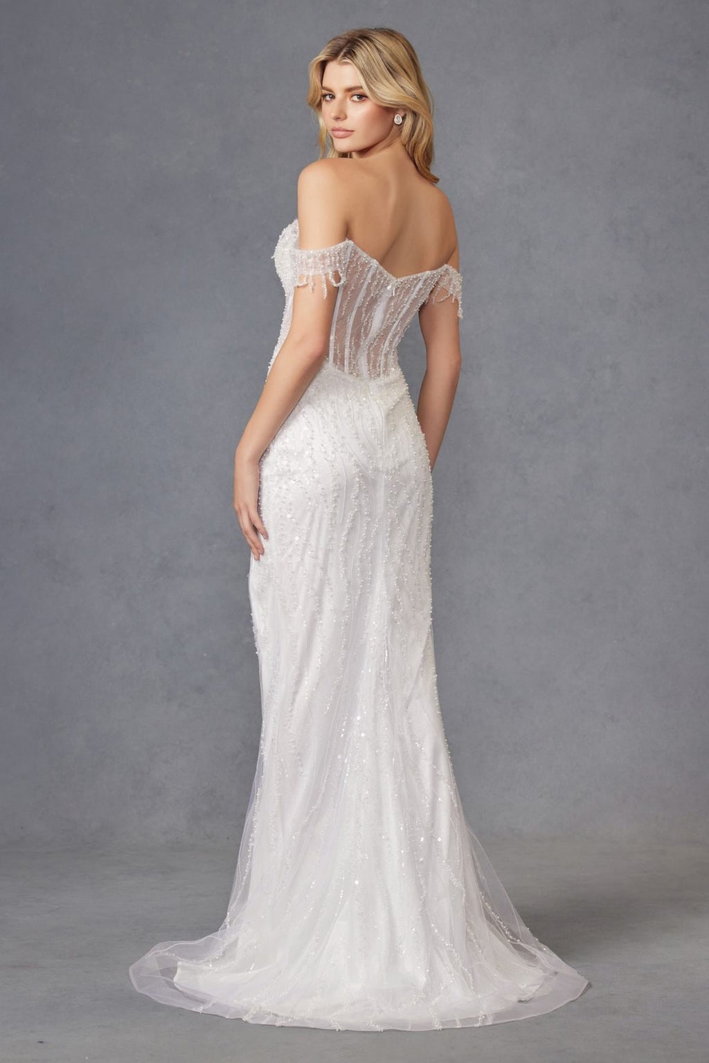 Off-white off-shoulder fitted wedding gown with fringe sleeve cuffs and flowing sheer skirt