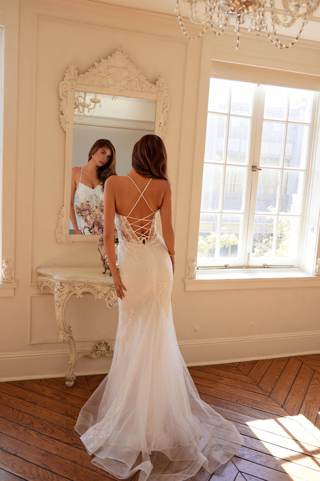 Off-white embellished lace mermaid bridal dress with lace-up back and long train.