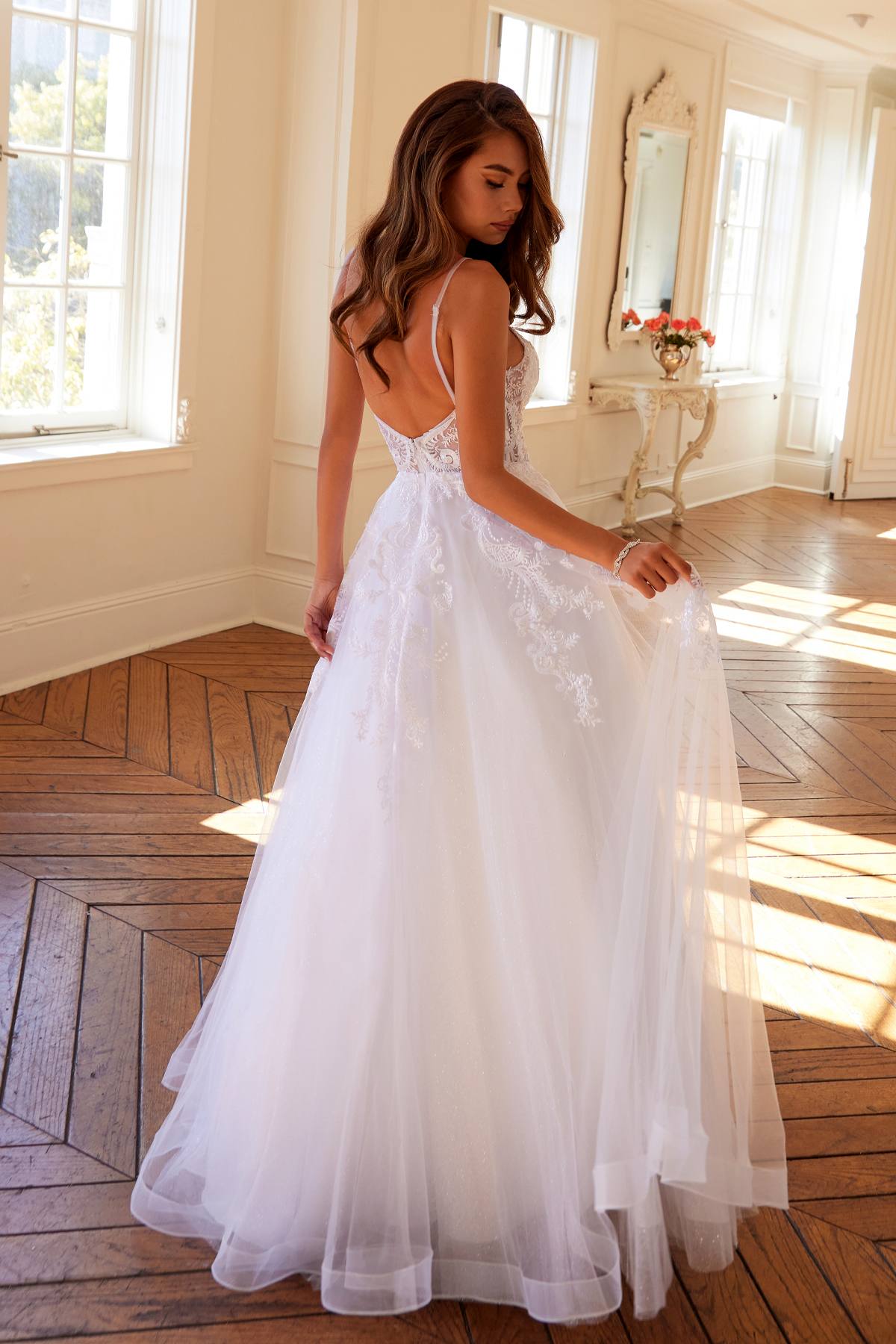 White A-line wedding ball gown with lace bodice, spaghetti straps, layered tulle skirt
