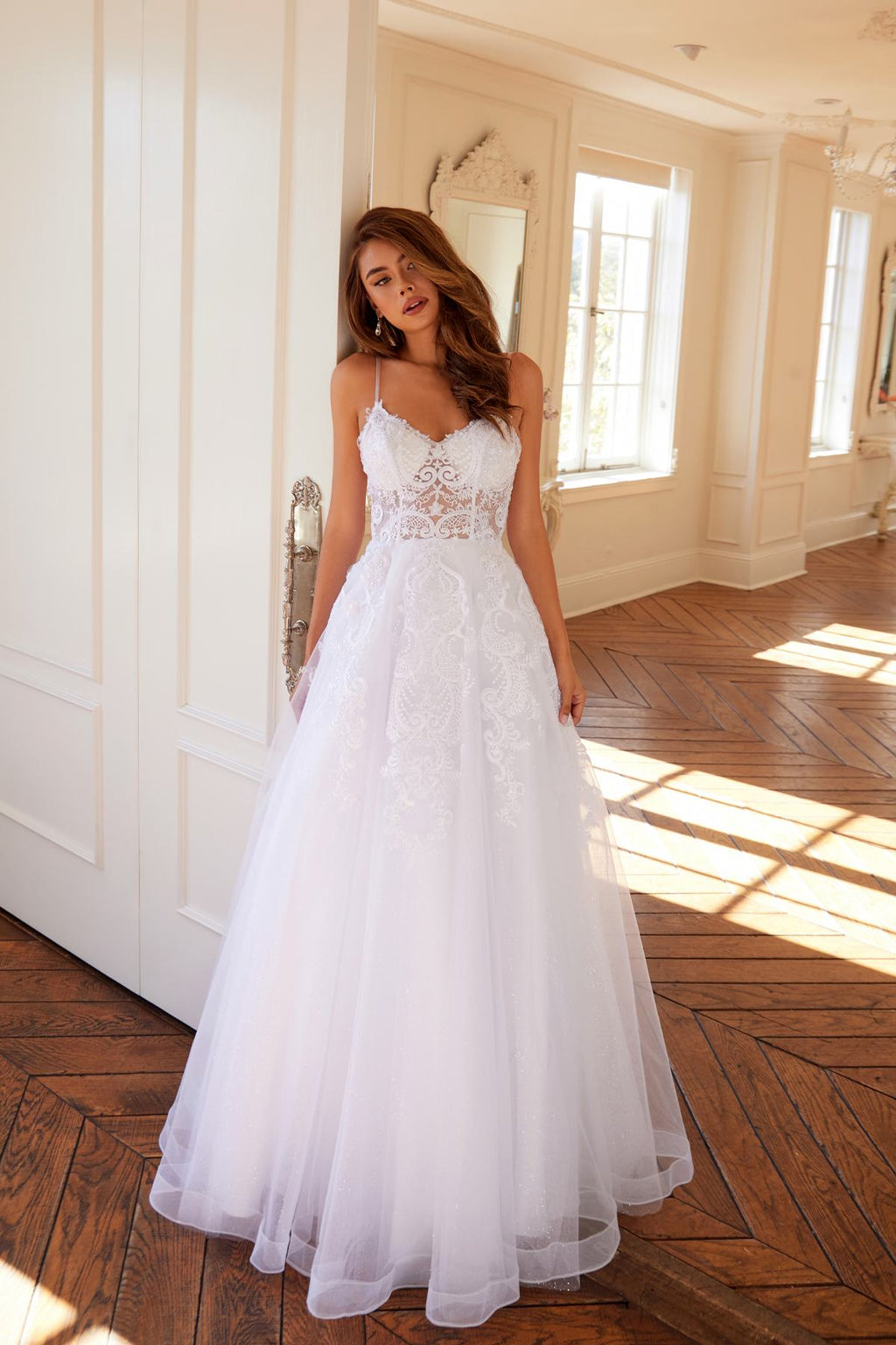 White lace wedding ball gown with spaghetti straps and full A-line tulle skirt