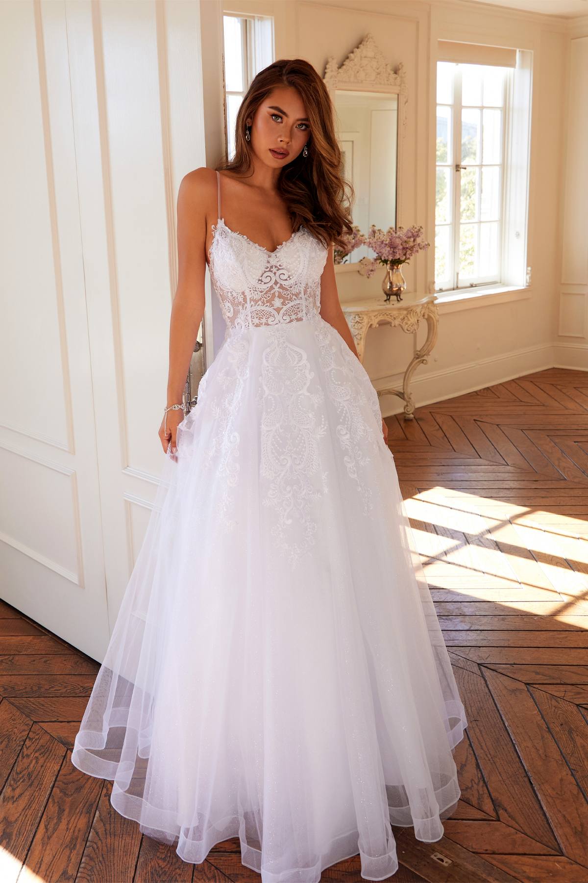 White lace wedding ball gown with spaghetti straps and A-line tulle skirt