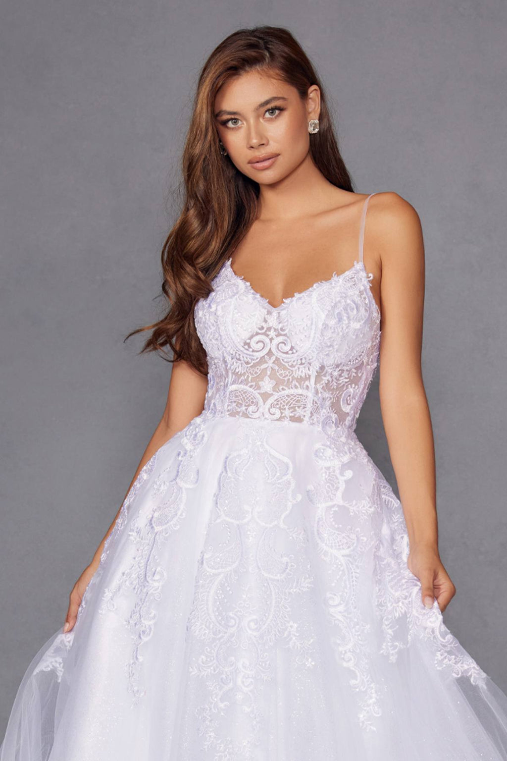 White lace bodice wedding gown with thin straps, floral appliqués, and full tulle skirt
