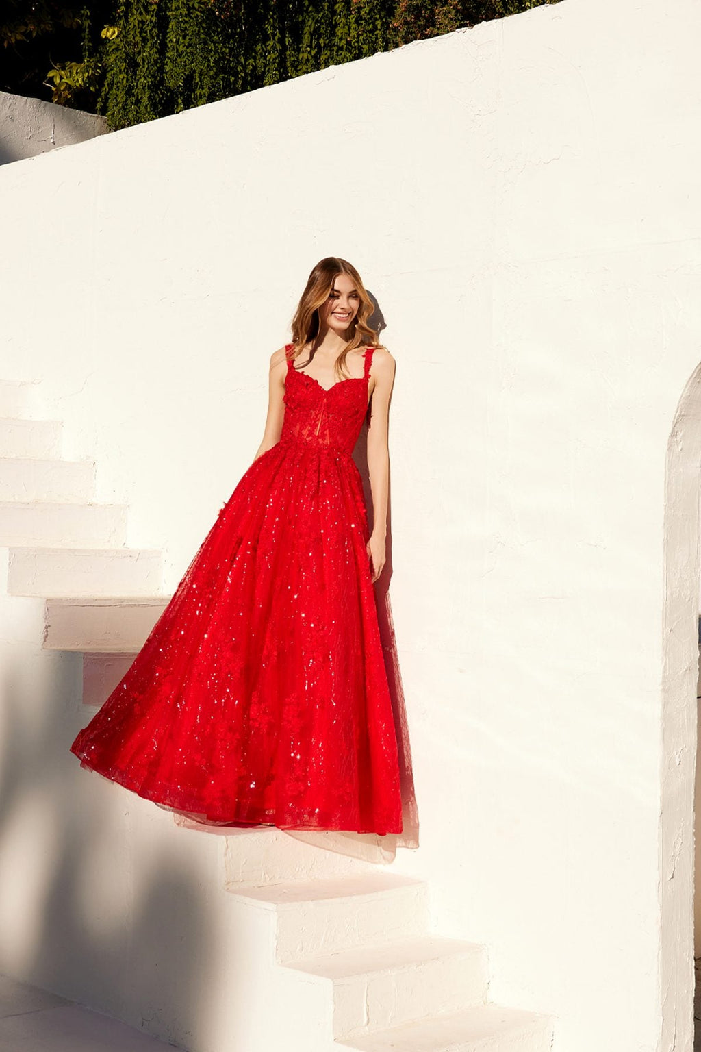 Red A-line evening gown with fitted bodice and full glittering skirt