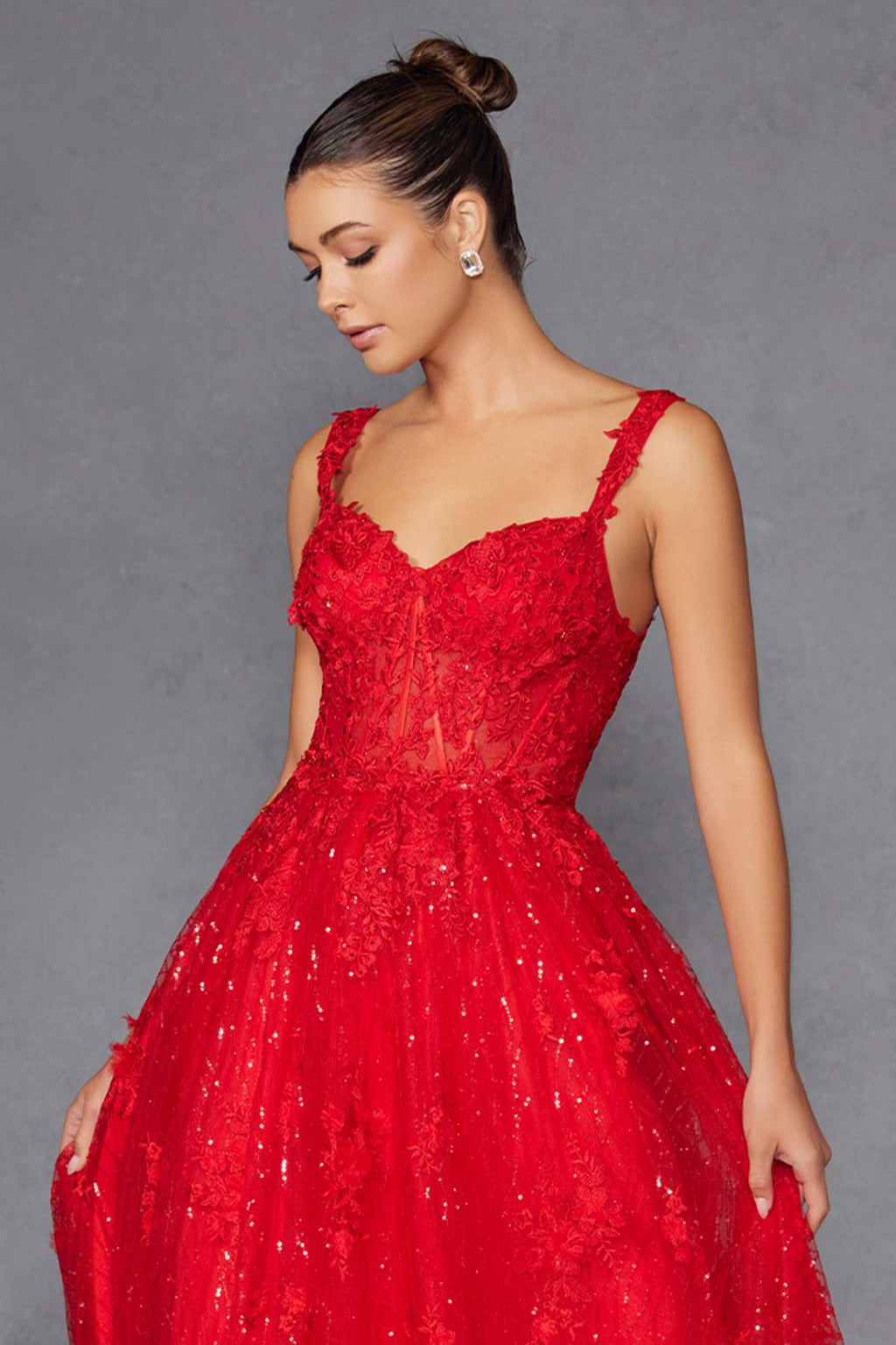 Red A-line evening gown with V-neck bodice and detailed glitter skirt