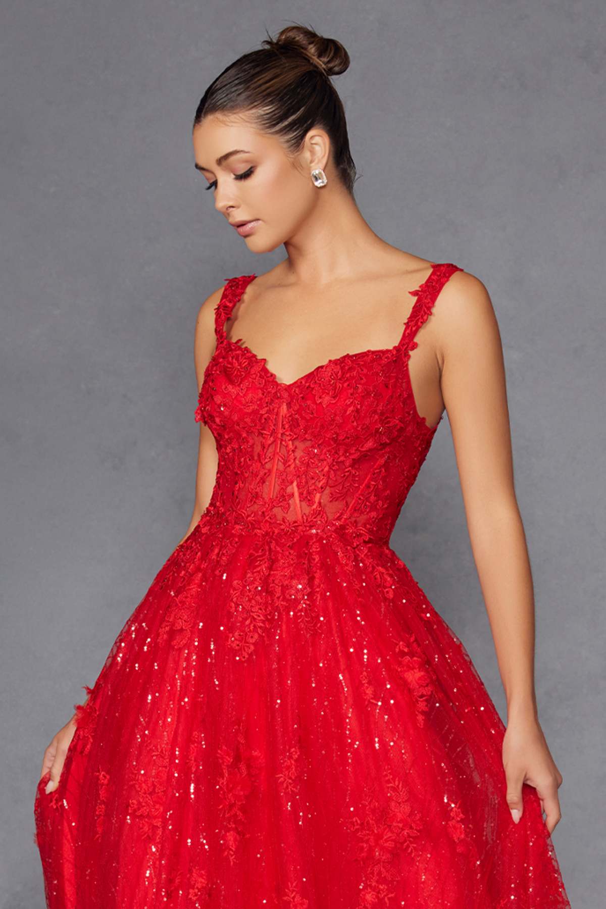 Red A-line evening gown with V-neck bodice and detailed glitter skirt